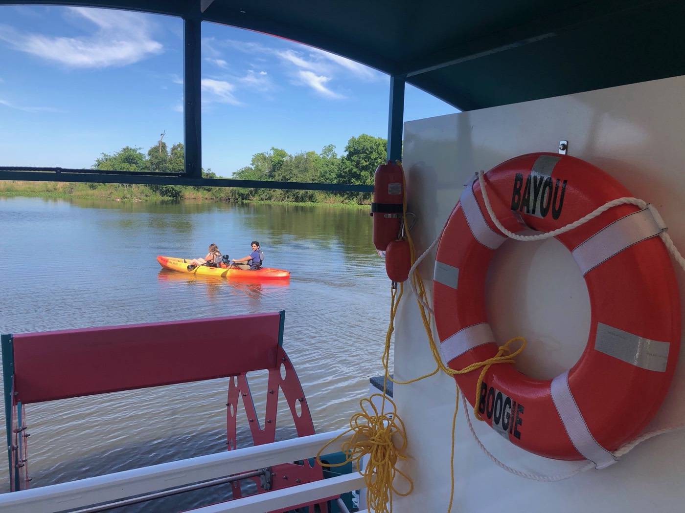 Kayakers on protected bayou water near the launch dock