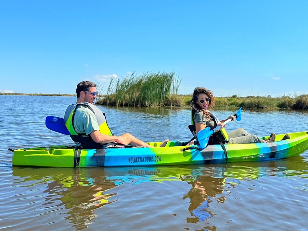 Couple in a tandem kayak on calm bayou water near New Orleans